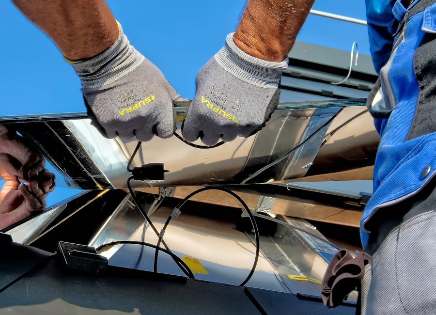 Technician hands wiring a solar panel